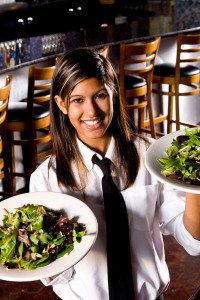 Hotel Hospitality Female Employee Holding Two Plates of Salad